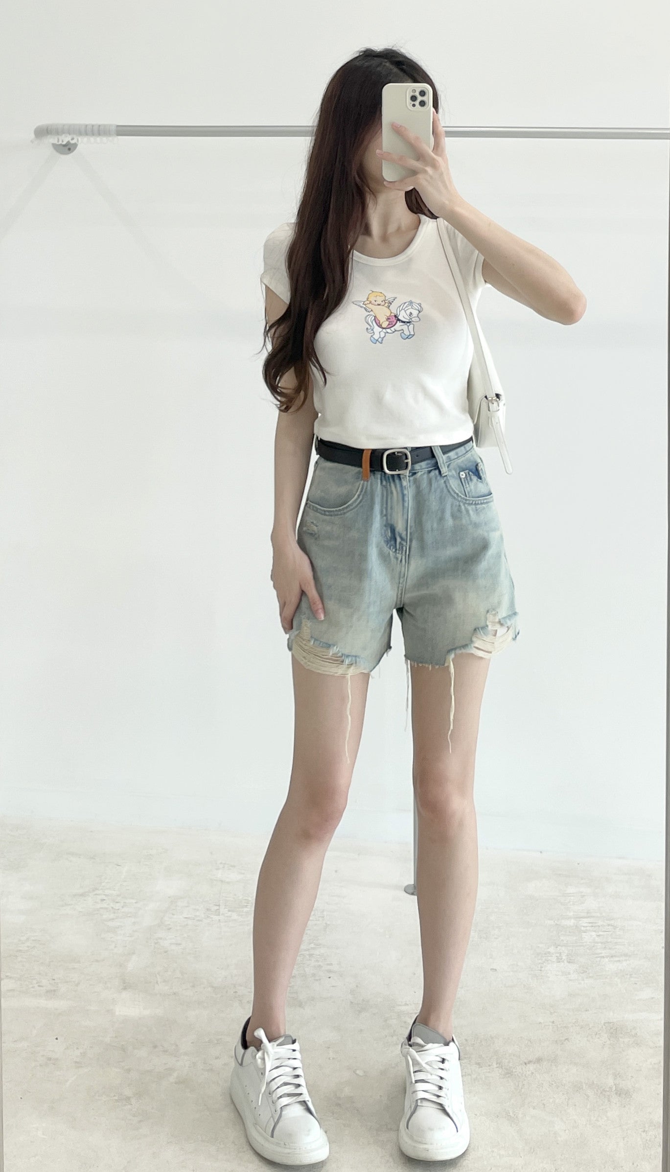 Belted high-waisted denim shorts