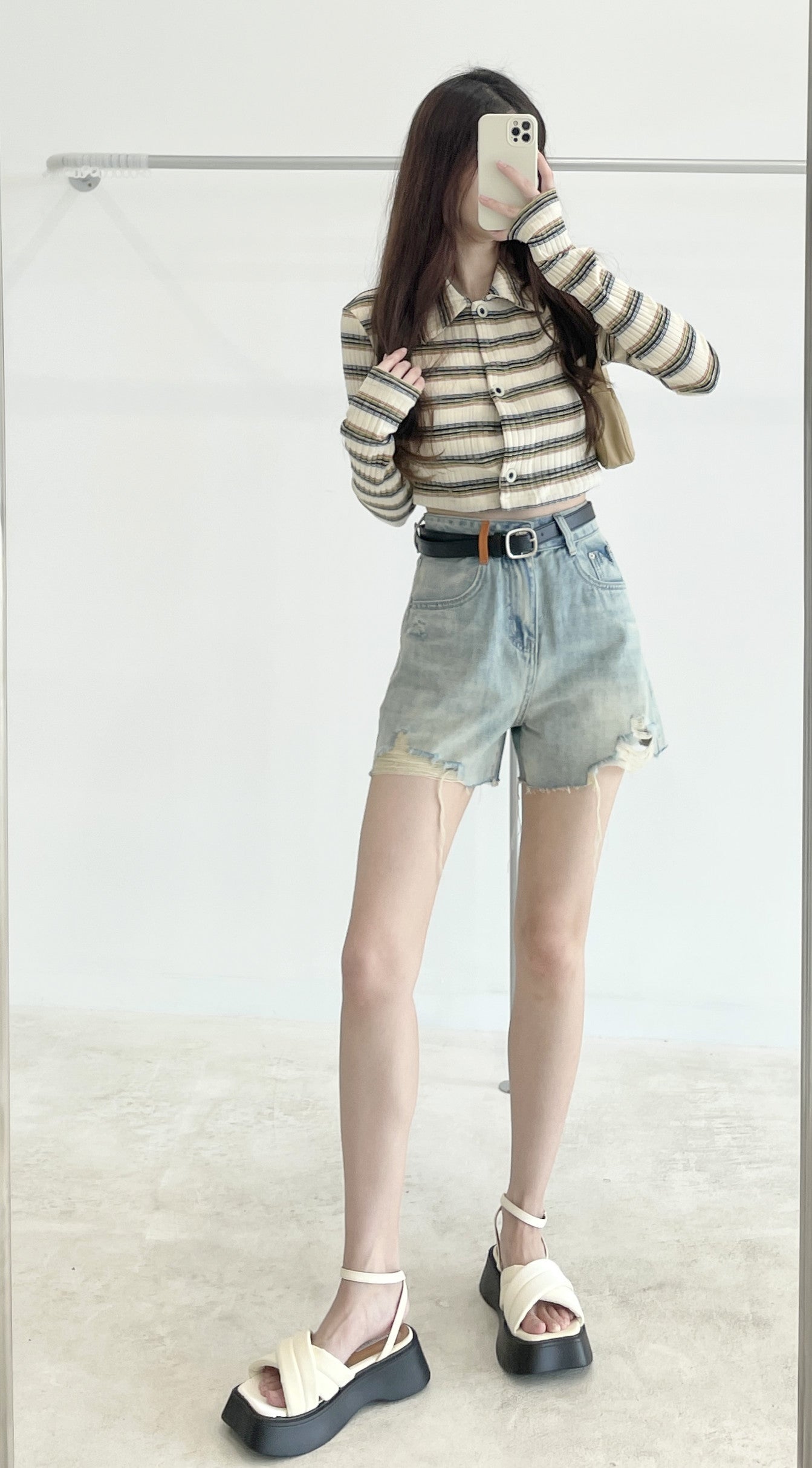 Belted high-waisted denim shorts